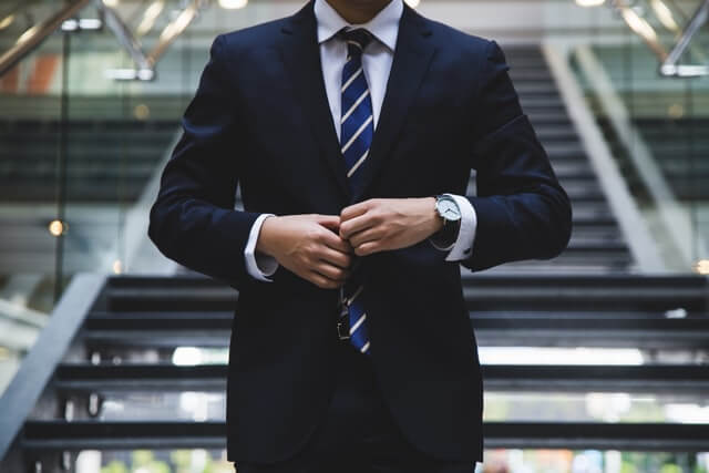 Man in a suit showing professionalism of Filipinos in providing IT solutions.